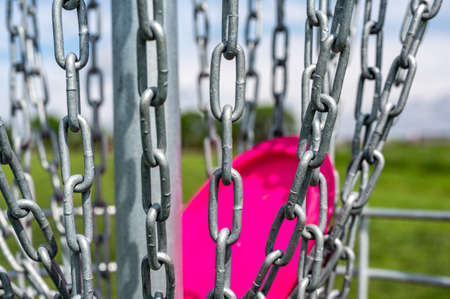 Different angles of view of a disc golf basket and chainsの写真素材