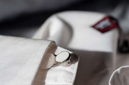 button extender shown on a white dress shirt to increase size