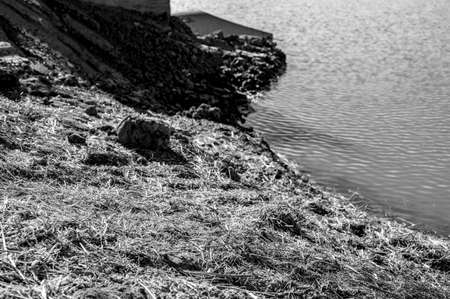 straw covered slope leading to a stormwater retention basin used to control soil erosion at a...