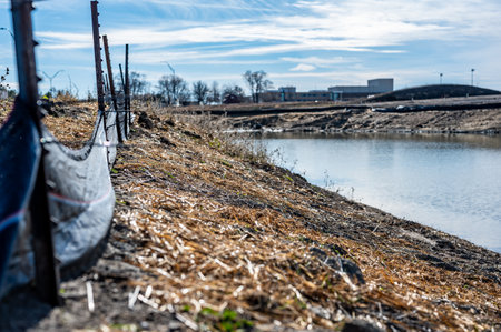 silt fence at a construction site with exposed dirt piled against the fabricの写真素材