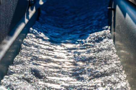 Ice and snow building up inside a rooftop gutter system on a residential houseの写真素材