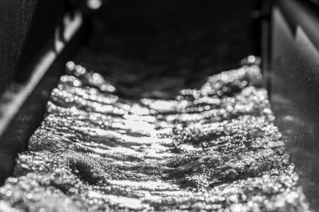 Ice and snow building up inside a rooftop gutter system on a residential houseの写真素材