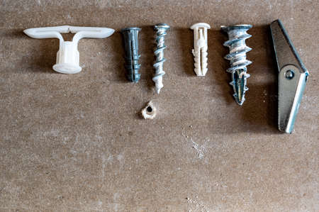 assortment of different drywall anchors used for hanging objects on wallsの写真素材