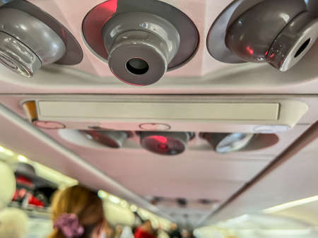 Selective focus on the air vent inside a commercial airplane general seating area.の写真素材