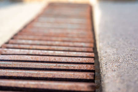 Grate over a stormwater trench in a concrete slab.の写真素材