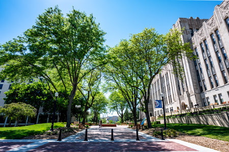 Omaha, Nebraska, US - 5.2022 - View down central sidewalk at Creighton University in the spring.のeditorial素材