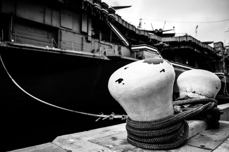 Selective focus on line securing a naval boat to a port bollard.の写真素材