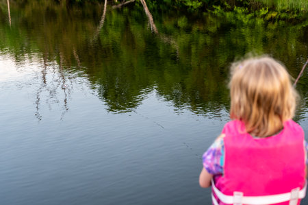 girl fishing with blue water in backgroundの写真素材