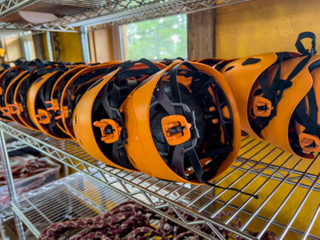 Row of helmets ready for use at a high ropes and climbing course.