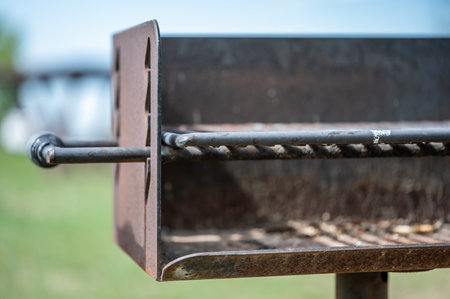 open metal grill at a public park area used for cooking food.