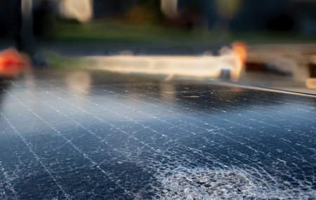 Damaged and cracked solar panel with fractured glass.