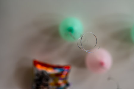 Selective focus on a curled ribbon tied to a balloon while looking up.