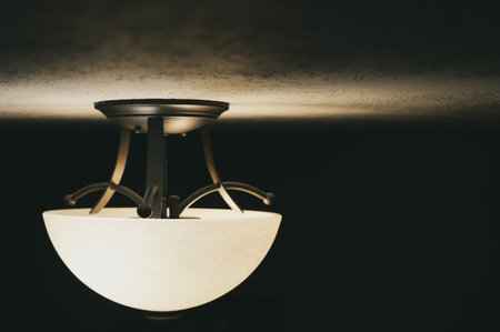 Eye level view of a modern light fixture on a white ceiling