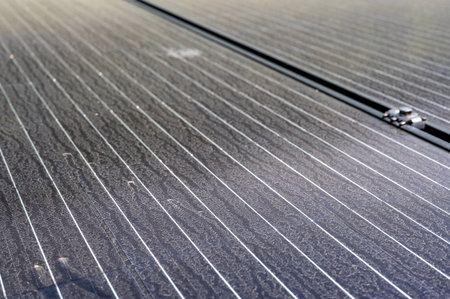 Flat laying solar panel with dust covering sections and reducing efficiency.