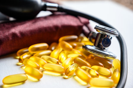 Omega 3 fish oil supplements with stethoscope and blood pressure cuffの写真素材