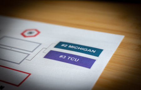 Tiffin, Iowa, USA - 12.2022 - Grainy Selective focus on 2022-2023 College Football Playoff Bracket.のeditorial素材