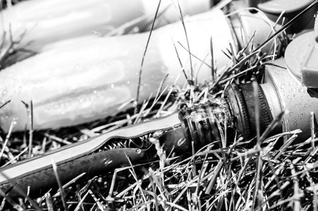 Frayed garden hose with burst section spraying water from the point of connectionの写真素材