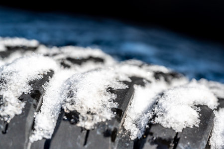 Closeup selective focus on snow packed in an all-weather tire tread.の写真素材