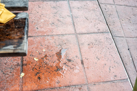 Spilled drink on a wooden picnic bench.の写真素材