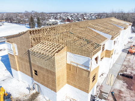 Aerial drone view of a multifamily apartment complex under construction.