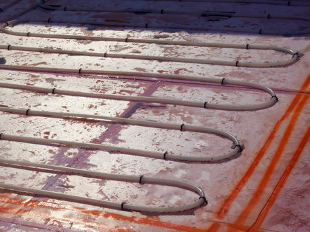 Loops of in-floor heat coils read for installation on polystyrene foam insulation.の写真素材