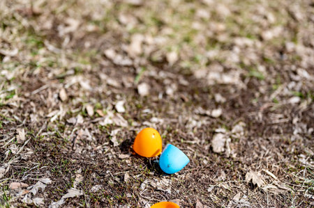 Open and discarded halves of plastic Easter eggs after a public hunt.