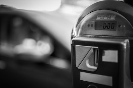 Selective focus on an expired parking meter with no time left.
