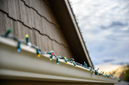 Hanging Christmas lights on gutter with plastic clips