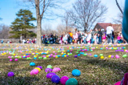 Open field with hundreds of plastic Easter eggs for a kids public hunt.の写真素材