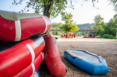 Row of inflatable rafts at the beginning of a float trip on a river.の写真素材