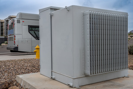 Selective focus on an electric transformer outside a commercial building.
