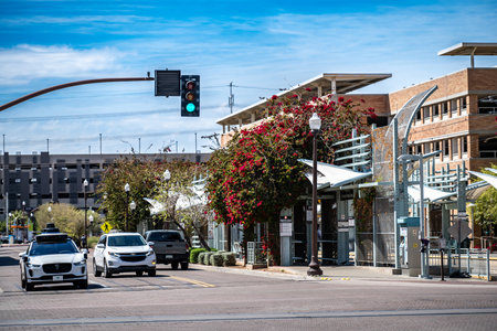 Phoenix, Arizona, USA - 3.23.2024: Behind a Waymo self-driving car going through a green light at an intersection.のeditorial素材