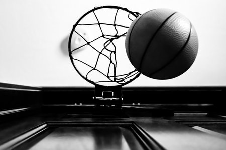 Selective focus on the netting of a miniature toy basketball hoop on the door of a bedroom.の写真素材