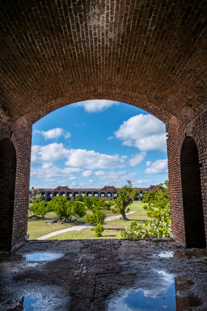 View through an open archway in Fort Jefferson on Dry Tortugas National Park with a the open courtyard a parade ground in the distance.の写真素材