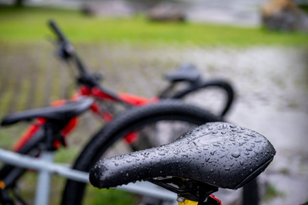 Selective focus on a wet bike seat in the rainの写真素材