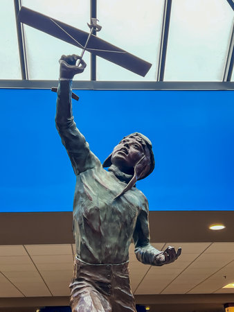 Sioux Falls, South Dakota, USA - 4.1.2024: statue of child flying a plane inside the airport...