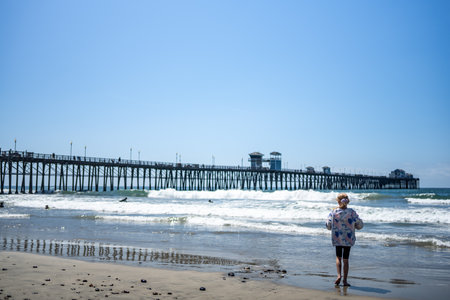 Oceanside City Beach with distant Municipal Pier and ocean waves.の写真素材