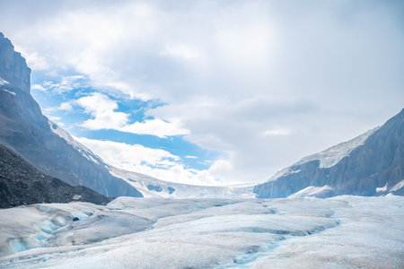View into the Athabasca Glacier in Jasper National Park with cloudy skyの写真素材