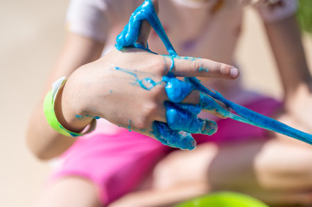 young girl playing with a gooey slimeの写真素材