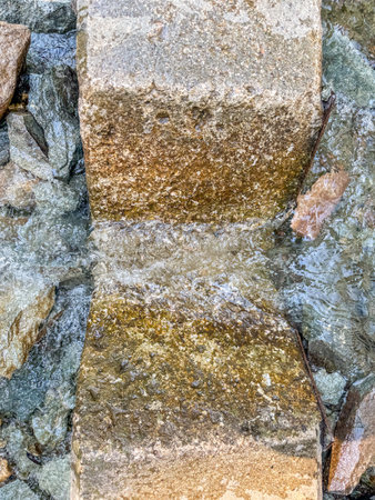 Top view of a V-notch weir cut into a concrete retaining wall for water restrictionの写真素材