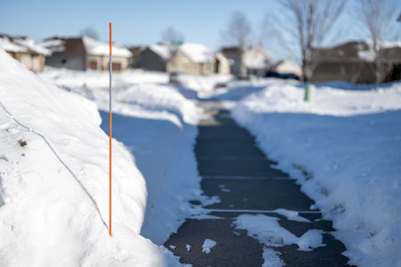 Sidewalk with edge markers used for snow blowing guidesの写真素材