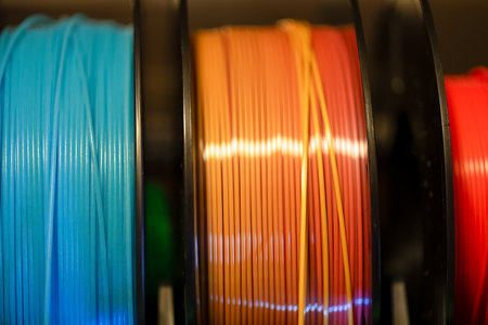Selective focus on different colored spools of 3d printer filamentの写真素材