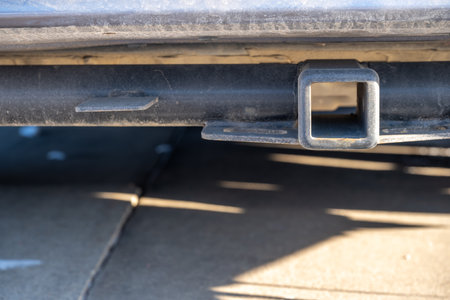 Selective focus on the front end of an empty square hitch receiver on the back end of a vehicle.の写真素材