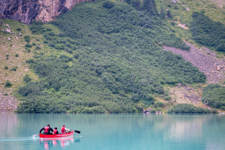 Tourists using a rented canoe in Lake Louise, Alberta, Canada