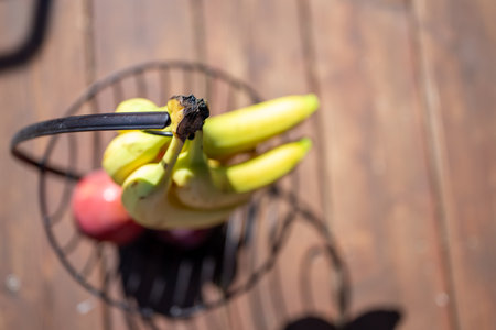 Fresh bunch of Bananas on a stand with several applesの写真素材