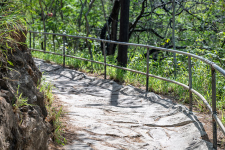 Selective focus on an uneven surface of the hiking trail to the summit of Diamond Head State Monument in Oahu, Hawaiiの写真素材