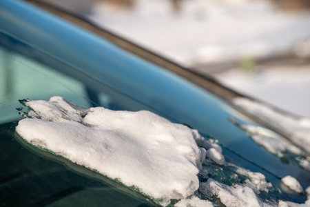 ice and snow on the front windshield of a vehicle.の写真素材