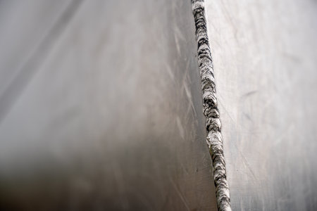 Selective focus on the weld bead and ground joint of stainless steal plats on the Gateway Arch National Park in St. Louis, Missouriの写真素材