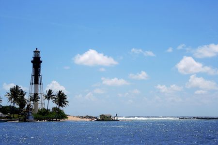 Black and white light house with clear blue sea.の写真素材