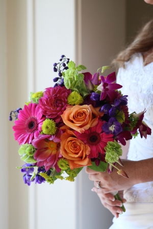 A bride holding a bright bouquet of flowersの写真素材